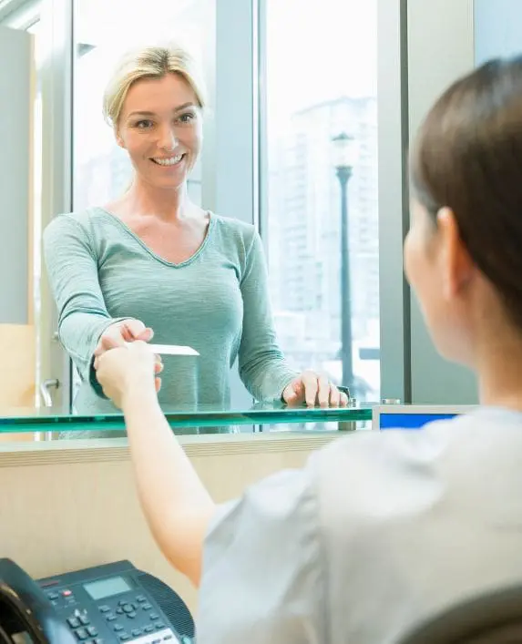 Dental patient talking to the dental receptionist