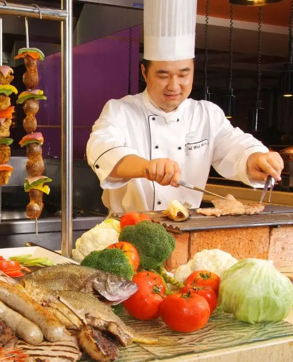 Chef in a restaurant cooking in a kitchen.