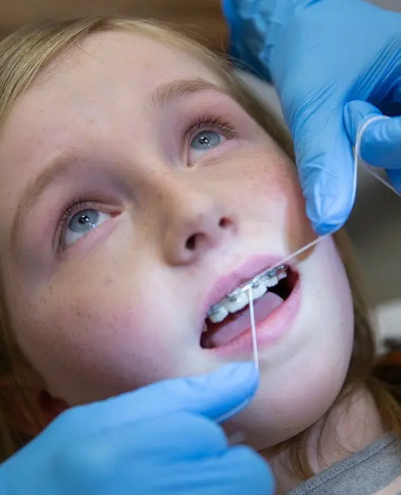 Girl at the orthodontist changing her wires