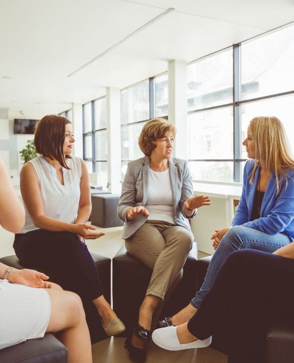 ladies sitting around in a group discussing an important topic