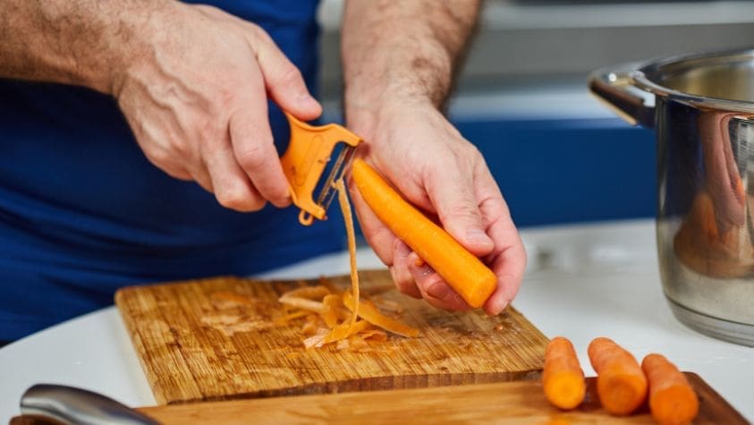 Somebody preparing carrots.
