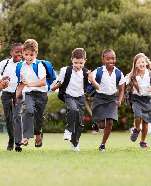 A group of children running on grass