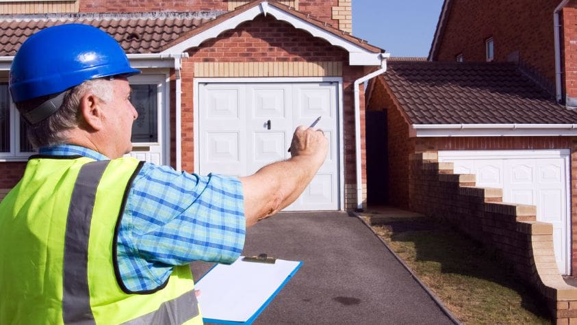 A man conducting a house building survey