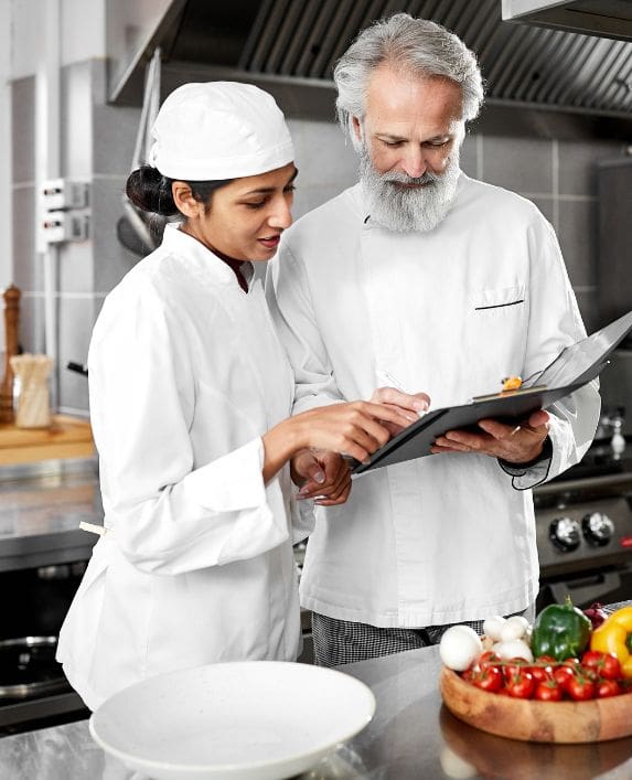 Level 3 food hygiene - Two people in a food business looking at a clipboard