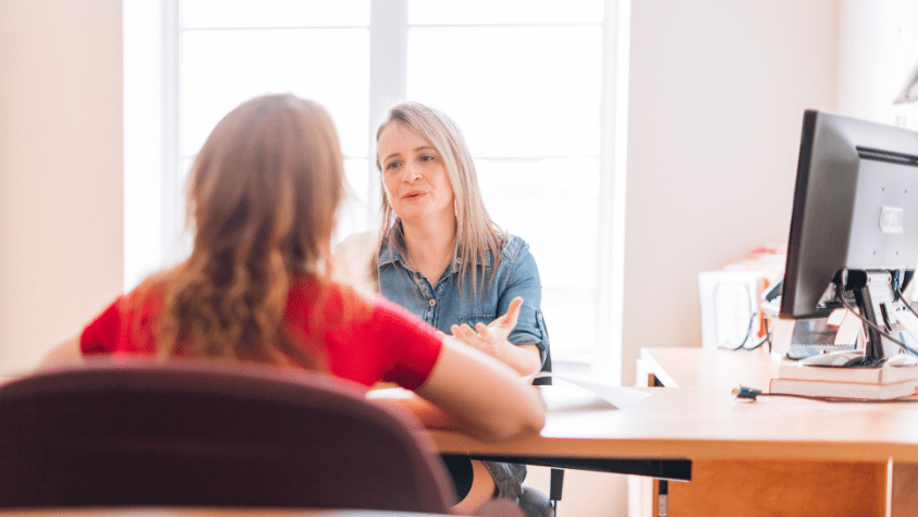 A volunteer being interviewed by an organisation
